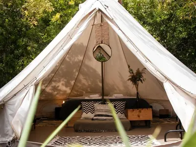 a white tent with a bed in it at Hoopoe Glamping in Virpazar