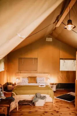 a bedroom with a large bed in a tent at Hoopoe Glamping in Virpazar
