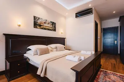 a bedroom with a large bed with two towels on it at Padam Hotel & SPA in Ulcinj