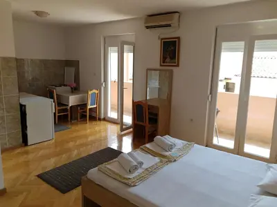 a room with a bed and a table with towels at Apartment Senka in Budva