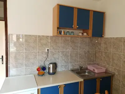 a kitchen with blue cabinets and a sink at Apartment Senka in Budva