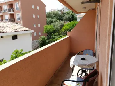 a balcony with a table and a view of a building at Apartment Senka in Budva