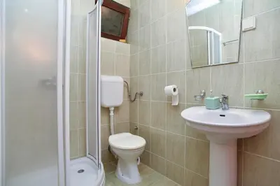 a bathroom with a toilet and a sink and a shower at Apartment Senka in Budva
