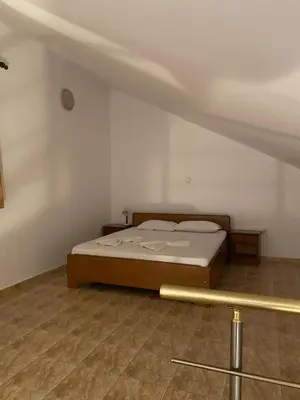 a bedroom with a bed in a room with at Apartments Toni in Ulcinj