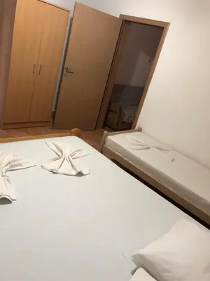 a small room with two beds and a mirror at Apartments Toni in Ulcinj