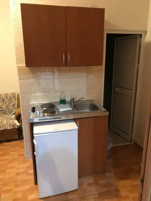 a small kitchen with a sink and a stove at Apartments Toni in Ulcinj