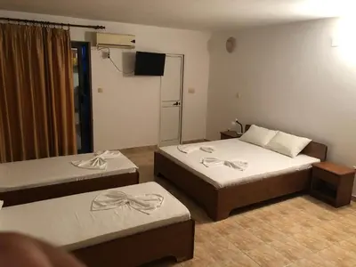 a hotel room with two beds and a television at Apartments Toni in Ulcinj