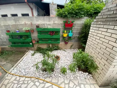 a garden with rocks and plants on a wall at Apartments Toni in Ulcinj