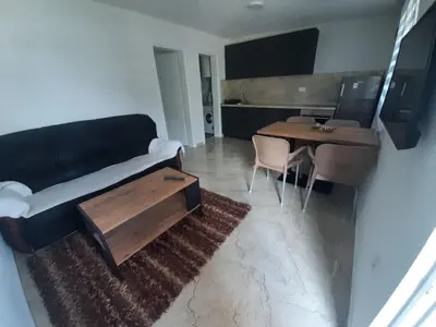 a living room with a couch and a table at Đuričić Apartmani in Budva
