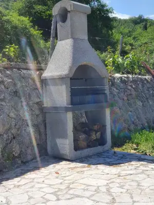 a stone oven with rocks inside of it at Banjo Rustic House Lake view in Virpazar