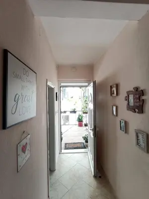 a hallway with a door leading to a yard at Kiwi Apartments Budva in Budva