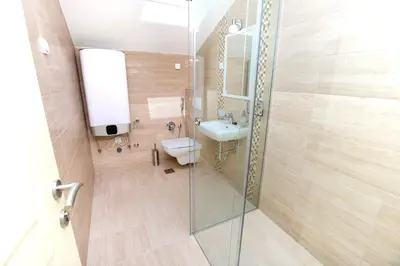 a bathroom with a shower and a toilet and a sink at Apartments Mezini 11 in Kotor