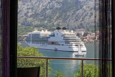 a cruise ship is docked in a harbor at Fortress View apartment in Kotor