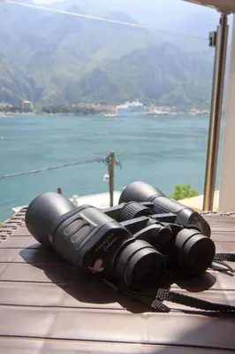 a pile of binoculars sitting on top of a wooden table at Fortress View apartment in Kotor
