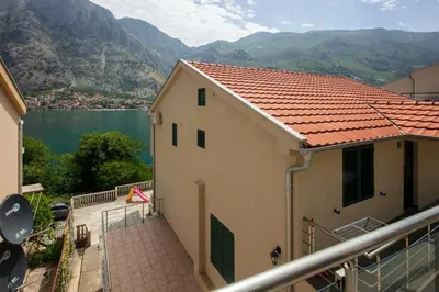 a building with a balcony with a view of a lake at Fortress View apartment in Kotor