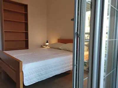a bedroom with a bed and a window at Studio Alexandra in Petrovac na Moru
