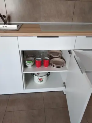 a kitchen cupboard with plates and bowls in it at Studio Alexandra in Petrovac na Moru