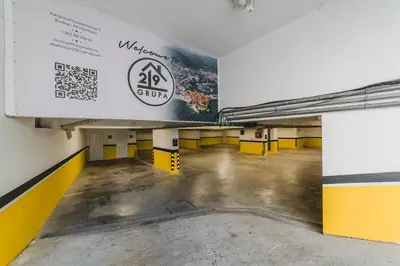 an empty parking garage with a large sign on the wall at Hotel 219 Budva in Budva