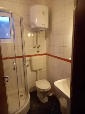 a bathroom with a toilet and a shower and a sink at Bungalo Đeković in Ulcinj
