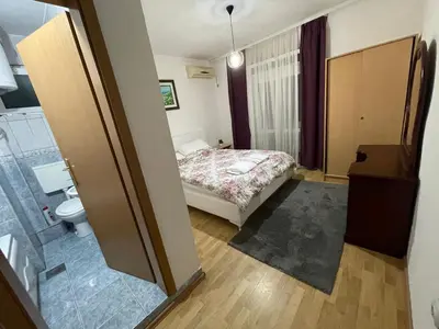 a small bedroom with a bed and a bathroom at Apartments Dibra in Ulcinj