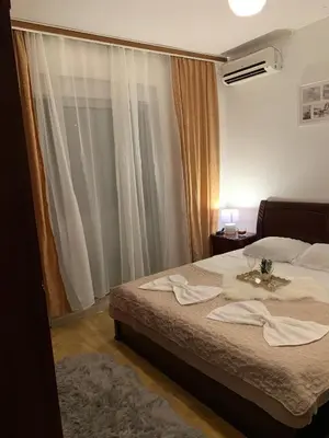 a bedroom with a bed with towels on it at Apartments Dibra in Ulcinj