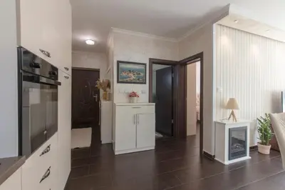 a living room with a kitchen and a hallway at ENA Apartment in Kotor