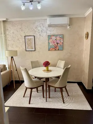 a dining room with a table and chairs at ENA Apartment in Kotor
