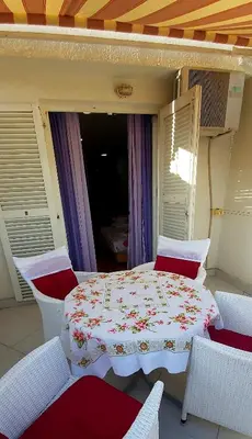 a table and chairs on a balcony with a table and chairs at Sunčani apartman 1-Vila Amfora in Budva