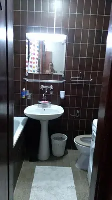 a bathroom with a sink and a toilet and a mirror at Sunčani apartman 1-Vila Amfora in Budva