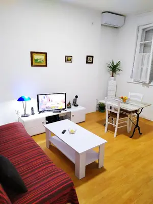 a living room with a couch and a table at Podgorica Center in Podgorica