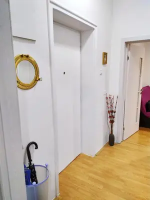 a hallway with a mirror and an umbrella in a bucket at Podgorica Center in Podgorica