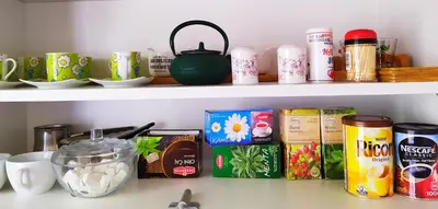 a kitchen shelf filled with food and drinks at Podgorica Center in Podgorica