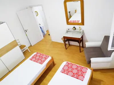 a living room with a couch and a mirror at Podgorica Center in Podgorica