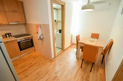 a small kitchen and dining room with a table at Portobello Old Town in Kotor