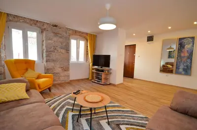 a living room with a couch and a tv at Portobello Old Town in Kotor