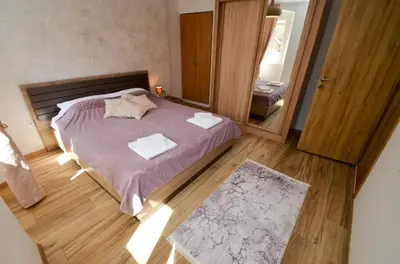 a small bedroom with a bed and a mirror at Portobello Old Town in Kotor