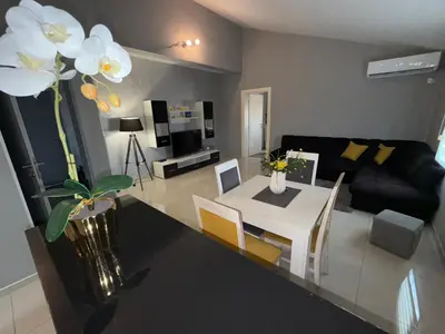 a living room with a table and a couch at Apartmani Stijepovic in Podgorica