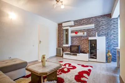 a living room with a couch and a tv at Stojkovic Family Apartments in Tivat