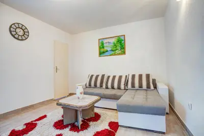 a living room with a couch and a table at Stojkovic Family Apartments in Tivat
