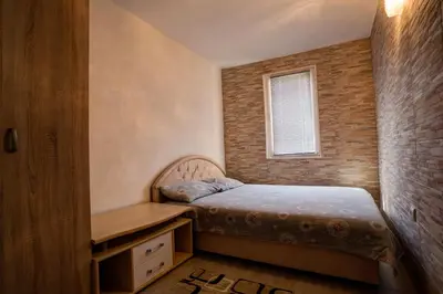 a small bedroom with a bed and a desk at Stojkovic Family Apartments in Tivat