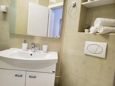 a bathroom with a sink and a mirror at MM Apartment in Budva