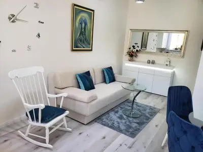 a living room with a couch and a chair at MM Apartment in Budva