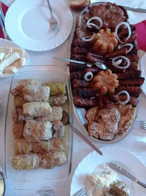 a table with several trays of food on it at Apartments Nino Skadar lake in Virpazar