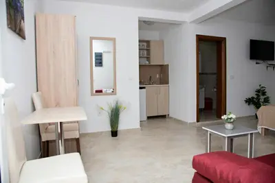 a living room with a couch and a table at Apartments Nino Skadar lake in Virpazar