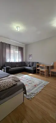 a living room with a bed and a couch at PriSMi STUDIO in Budva
