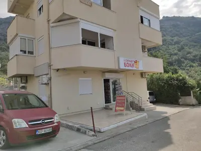 a building with a red car parked in front of it at PriSMi STUDIO in Budva