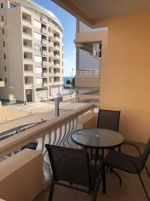 a patio with a table and chairs on a balcony at Dragovoja Lux Apartments & Rooms in Ulcinj