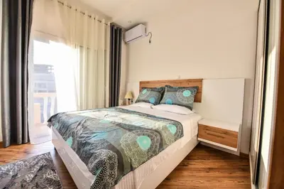 a bedroom with a large bed and a window at Dragovoja Lux Apartments & Rooms in Ulcinj