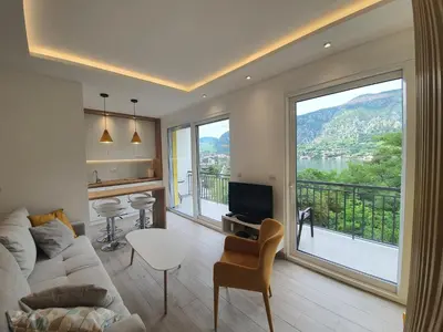 a living room with a couch and a large window at Viola lux apartments in Kotor