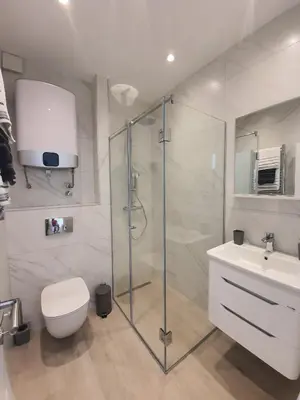 a bathroom with a shower and a toilet and a sink at Viola lux apartments in Kotor
